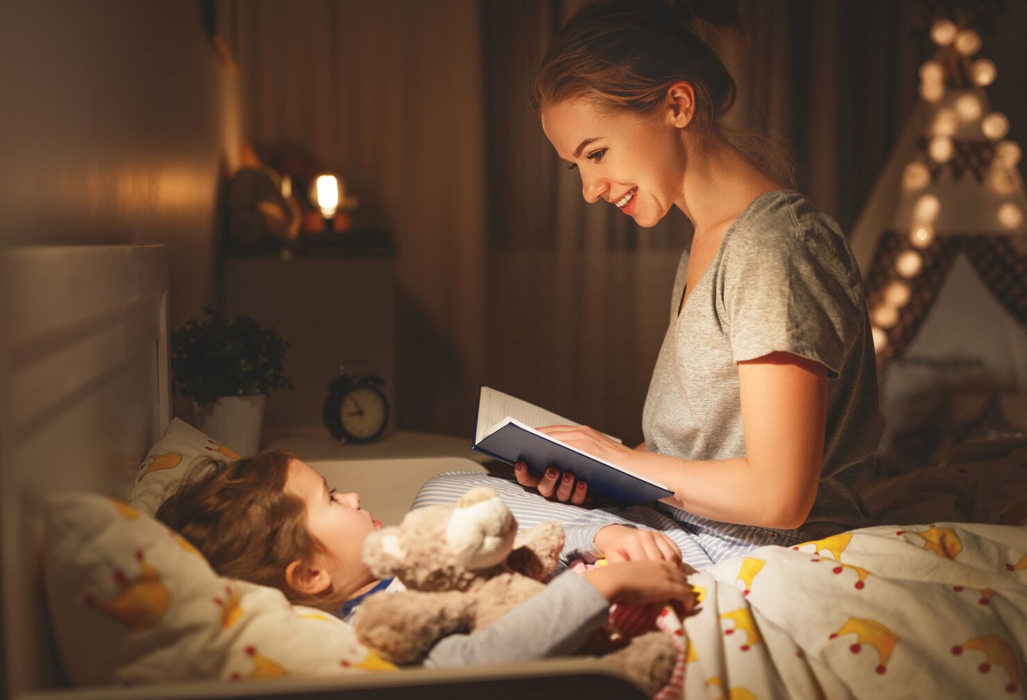 Eine Mutter liest ihrem Kind eine Gute Nacht Geschichte vor vor
